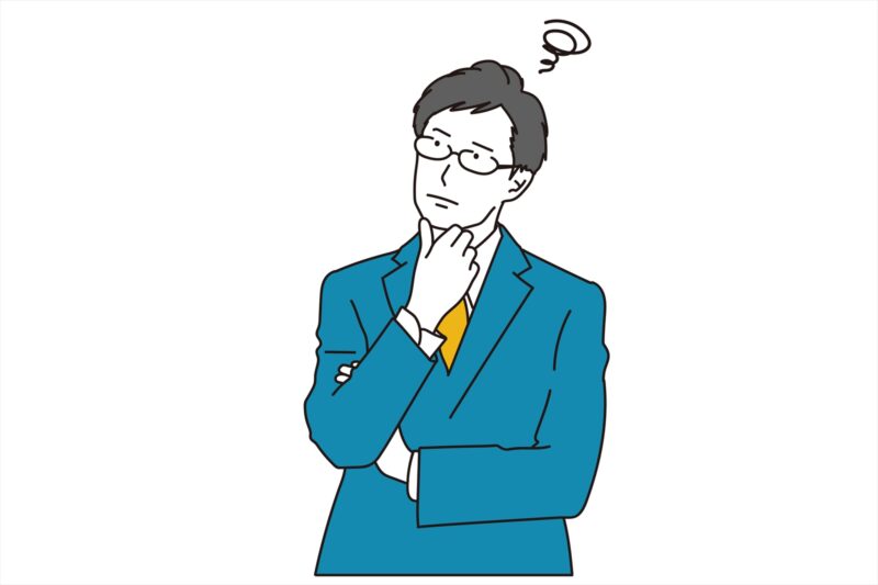 首を傾げる男性ビジネスパースン