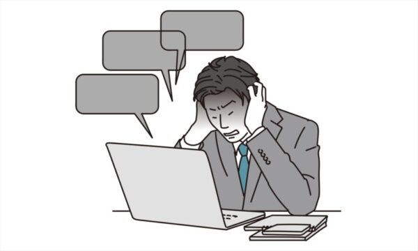 無理な要求に頭を抱える男性サラリーマン