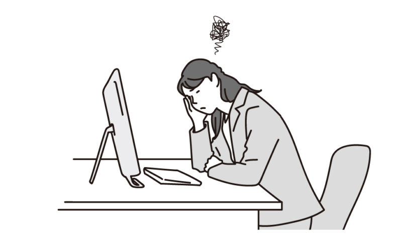 PCの前で悩む女性ビジネスパースン