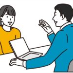 女性来訪者に説明する男性ビジネスパースン